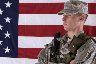 An image of a soldier with the American flag in the background.